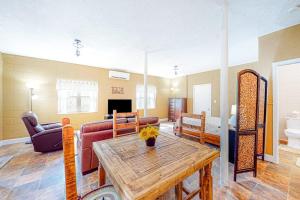 a living room with a table and a couch at Cozy Mountain Hideaway in Waynesville +16 photos