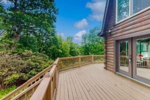 a wooden deck on the side of a house at Walela Cabin in Topton