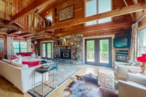 a living room with a couch and a fireplace at Walela Cabin in Topton