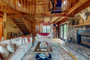 a living room with a couch and a fireplace at Walela Cabin in Topton