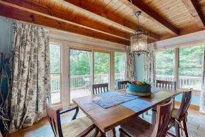 a dining room with a wooden table and chairs at Walela Cabin in Topton