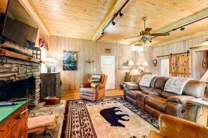 a living room with a couch and a fireplace at Bradley Bear Hideaway in Maggie Valley