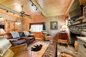 a living room with a couch and a fireplace at Bradley Bear Hideaway in Maggie Valley