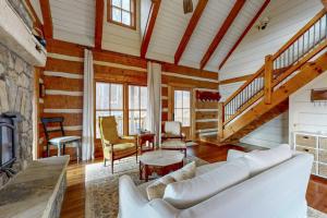 a living room with a couch and a fireplace at Moss Creek Cabin in Sylva