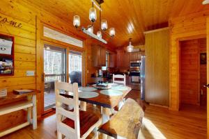 a dining room with a table and a kitchen at The Rushing Creek Cabin in Topton +27 photos
