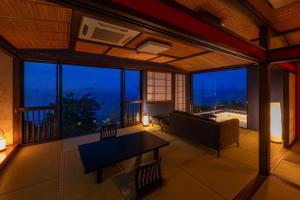 a living room with a couch and a table at 絶景海風癒し庵 新八屋 in Toba +86 photos