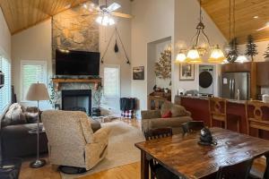 a living room with a table and a fireplace at Simple blessings in Bryson City