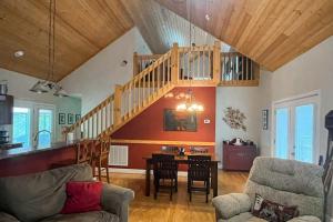 a living room with a staircase and a dining room at Simple blessings in Bryson City