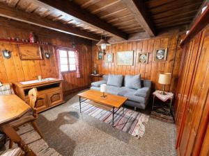 a living room with a couch and a table at Almhütte Seebergalm in Seewiesen