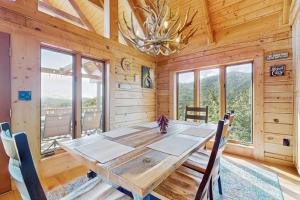a dining room with a wooden table and chairs at Slice of the Mountain in Franklin