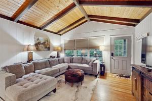 a living room with a couch and a table at Campfire Hideaway in Highlands