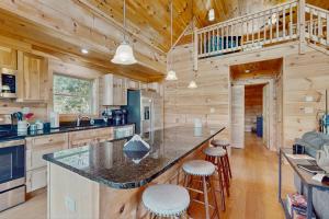 a kitchen with a large island in a log cabin at Nanuk in Franklin