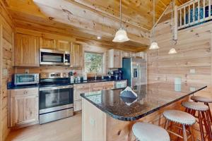 a kitchen with a counter top and wooden walls at Nanuk in Franklin +19 photos