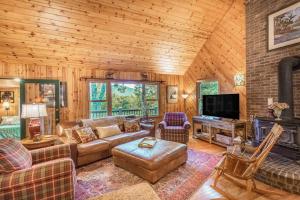 a living room with a couch and a fireplace at The Treehouse in Franklin