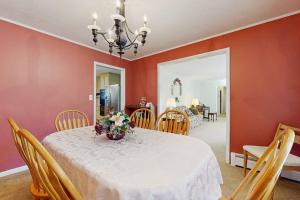 a dining room with a table with a vase of flowers on it at Shelba's Place in Sylva