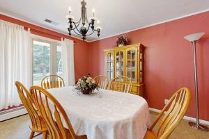 a dining room with a white table and chairs at Shelba's Place in Sylva