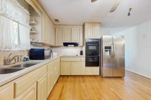 a kitchen with a stainless steel refrigerator and wooden cabinets at Shelba's Place in Sylva +13 photos
