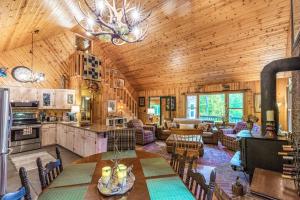 a kitchen and living room with a table and chairs at The Treehouse in Franklin +32 photos