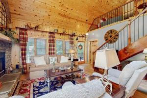 a living room filled with furniture and a staircase at Peak and Pond Retreat in Scaly Mountain