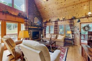 a living room with a couch and a fireplace at Peak and Pond Retreat in Scaly Mountain