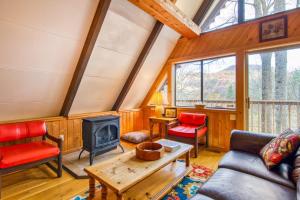 a living room with a couch and a fireplace at Chalet at Peek's Creek in Franklin