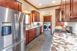 a kitchen with stainless steel appliances and wooden cabinets at Altitude with Gratitude in Whittier +23 photos