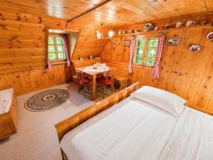 a bedroom with a table and a bed in a cabin at Almhütte Seebergalm in Seewiesen