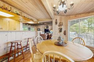 a dining room with a wooden table and chairs at Vista Heights Retreat in Bryson City