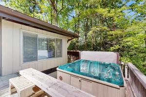 a hot tub on the deck of a house at Vista Heights Retreat in Bryson City