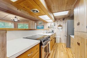 a kitchen with a stove and a refrigerator at Vista Heights Retreat in Bryson City +12 photos