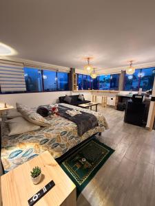 a bedroom with a bed and a living room with windows at La Marteja in Salento