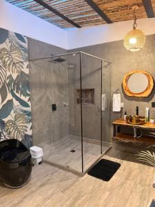a bathroom with a shower with a sink and a mirror at La Marteja in Salento +175 photos