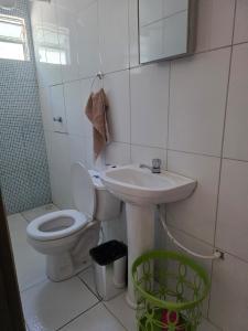 a bathroom with a toilet and a sink at Mirante in Crato +13 photos