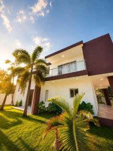 a house with palm trees in front of it at Villa costa mar in Cabrera