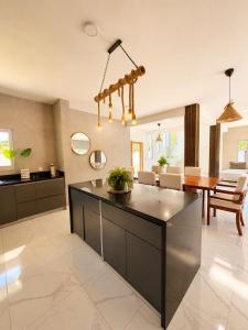 a kitchen with a large island in a living room at Villa costa mar in Cabrera