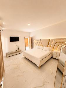 a bedroom with a bed and a flat screen tv at Villa costa mar in Cabrera