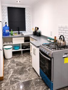 a kitchen with a stove and a sink at Cabaña bosquepaz in Algarrobo