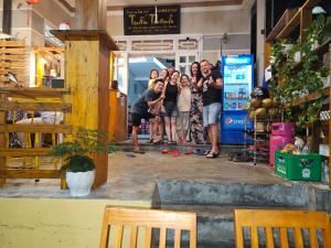 a group of people posing for a picture in a store at Tuan Thanh Homestay in Tân Hiệp