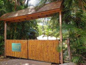 a wooden gate with a sign in front of a fence at Hawaiian Dream Temple in Kaupakulua