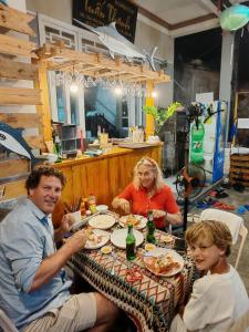 a group of people sitting at a table eating food at Tuan Thanh Homestay in Tân Hiệp