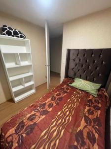 a bedroom with a bed with a black head board at Los Laureles -Executive Residence Departamento in Lima
