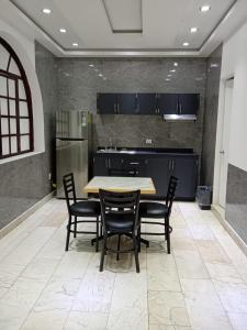 a kitchen with a table and chairs in a room at London 248 in Mexico City