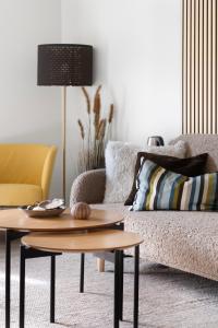 a living room with a couch and a table at Værøy Brygge Hotell in Værøy