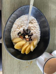 a bowl of oatmeal with bananas and raisins at One Ocean Nature Conservation Centre in Kota Belud