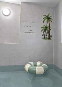 a room with a bean bag chair in a room with a palm tree at Paju Espacio Brillante in Paju