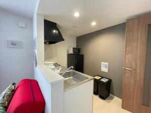 a small kitchen with a sink and a refrigerator at イーエフ千歳駅 in Chitose +74 photos