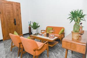 a room with chairs and a table and a couch at Dewandaru Homestay 2 in Tonogoro