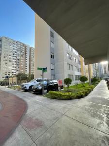 a parking lot with cars parked in front of a building at Los Laureles -Executive Residence Departamento in Lima