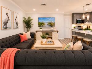 a living room with a couch and a table at Tropical Dream - Pool - Firepit - Gazebo in Largo