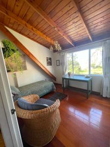 a living room with a couch and a table at MoonWillow Manor in Dairy Flat +1 photo